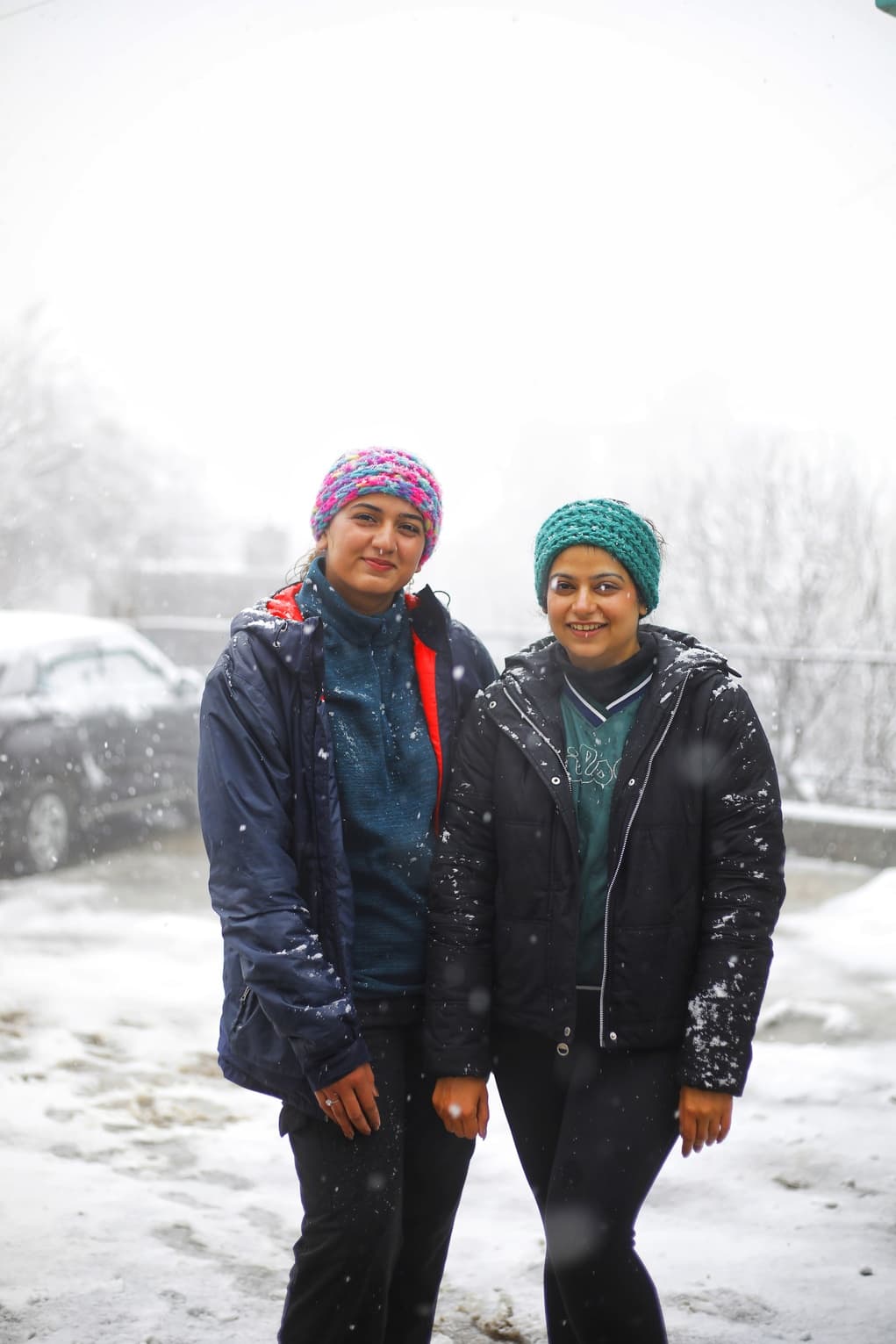 Group photo outside a snowy building entrance - Image 2
